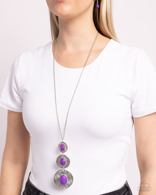 <p>Mismatched emerald and oval cut purple acrylic beads adorn the centers of scratched silver discs that gradually increase in size as they link at the bottom of a lengthened silver chain. The beads vary in faceted and smooth finishes, adding a trendy finish to the colorful talisman-like pendant. Features an adjustable clasp closure.</p> <p><i>Sold as one individual necklace. Includes one pair of matching earrings.</i></p>