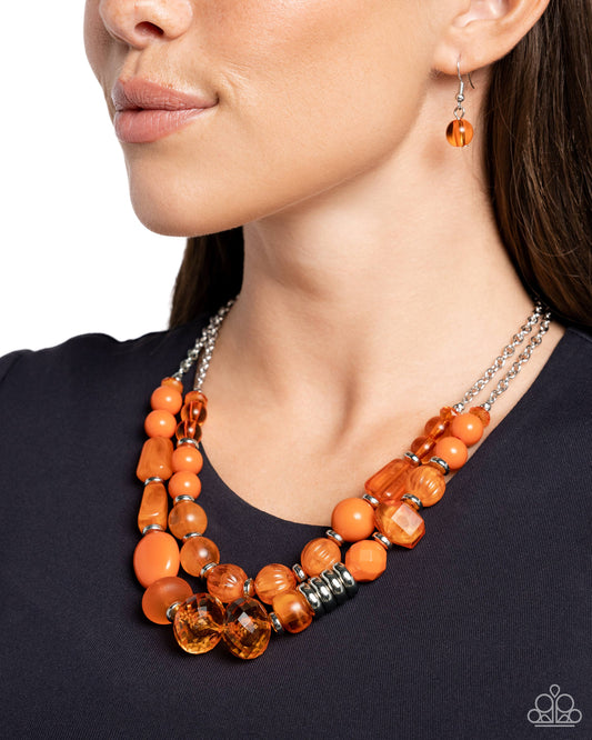 <p>Varying in shape, size, and opacity, a refreshing collection of orange acrylic and crystal-like beads join silver discs along invisible wires that flawlessly layer below the collar for a vivacious pop of color. Features an adjustable clasp closure.</p> <p><i>Sold as one individual necklace. Includes one pair of matching earrings.</i></p>