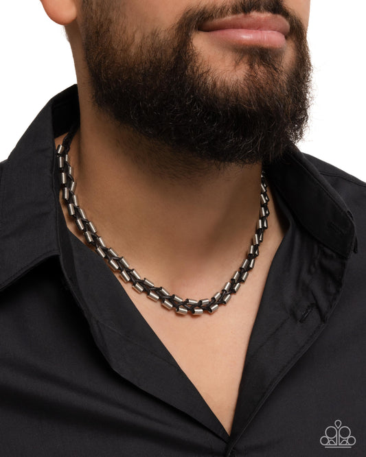 <p>Featuring dainty silver beads that are rippling with ribbed textures, black suede cords decoratively braid and weave below the collar for an urban flair. Features a button loop closure.</p> <p><i> Sold as one individual necklace.</i></p>