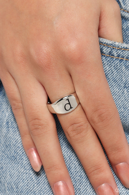 <p>Pressed into the center of a beveled silver band, the black letter "d" stands out for a simple, sentimental centerpiece. Features a stretchy band for a flexible fit.</p> <p><i> Sold as one individual ring.</i></p>