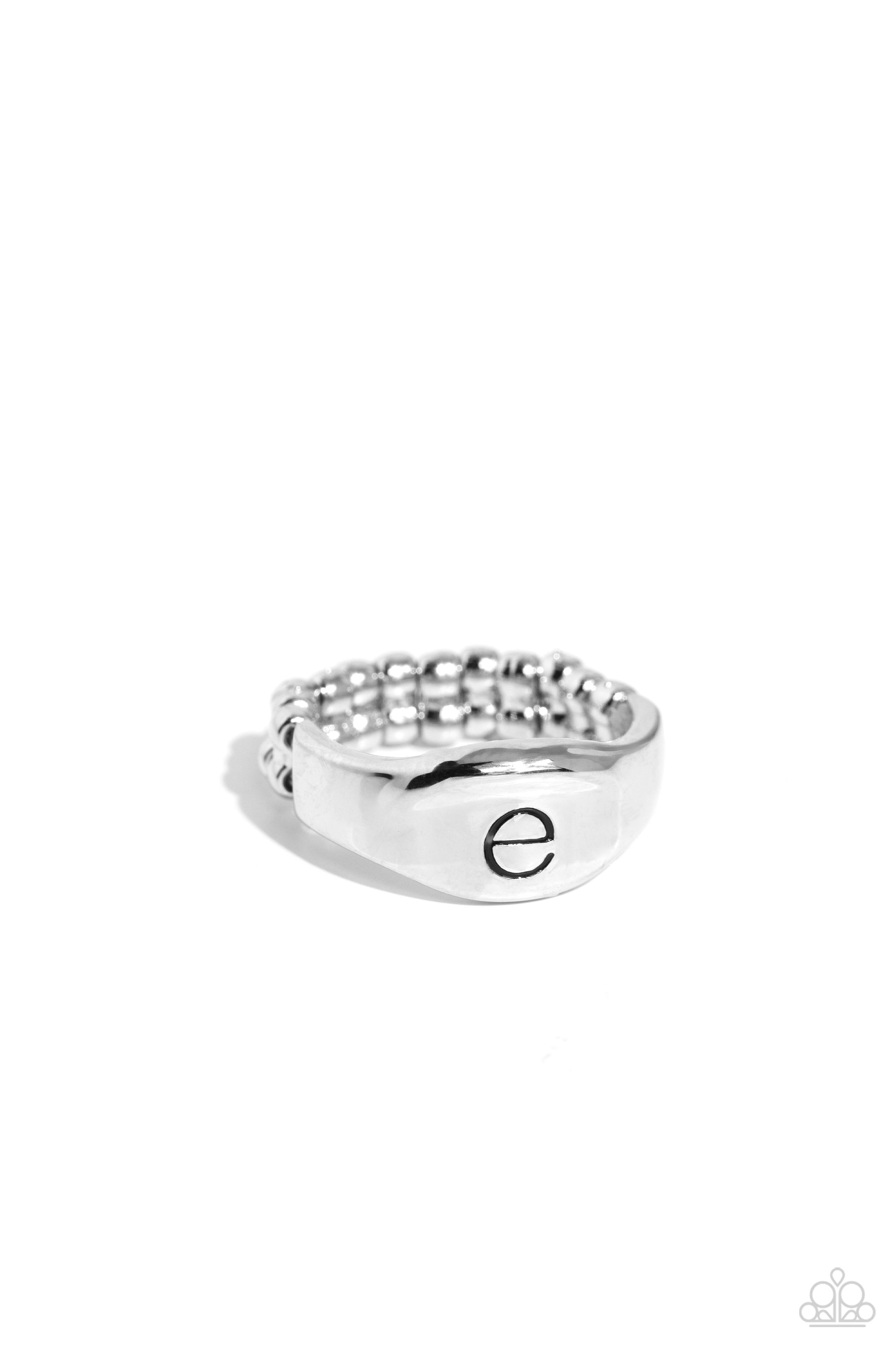 <p>Pressed into the center of a beveled silver band, the black letter "e" stands out for a simple, sentimental centerpiece. Features a stretchy band for a flexible fit.</p> <p><i> Sold as one individual ring.</i></p>