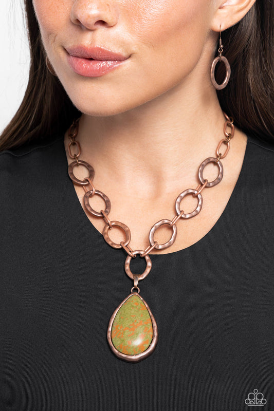 <p>Swinging from a collection of hammered copper rings, an oversized abstract green and orange stone teardrop creates an earthy everyday look. Features an adjustable clasp closure. As the stone elements in this piece are natural, some color variation is normal.</p> <p><i> Sold as one individual necklace. Includes one pair of matching earrings.</i></p>
