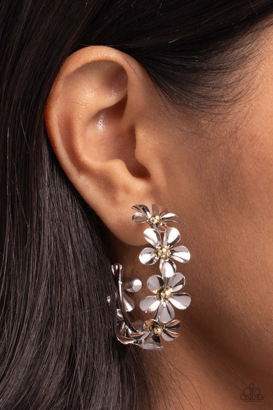 <p>Featuring gold bead centers, metallic silver flowers whimsically curl around the ear for a neutral floral display. Earring attaches to a standard post fitting. Hoop measures approximately 1 1/2" in diameter.</p> <p><i> Sold as one pair of hoop earrings.</i></p>