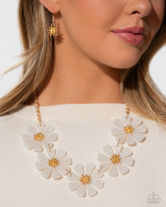 <p>Featuring a soft, speckled pattern, a collection of white acrylic flowers bloom around tactile gold studded centers for a whimsical display around the neckline. Features an adjustable clasp closure.</p> <p><i> Sold as one individual necklace. Includes one pair of matching earrings.</i></p>