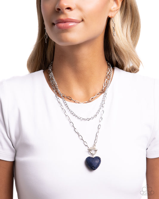 <p>Three mismatched silver chains coalesce and layer down the chest for a monochromatic display. A Montana-beaded heart charm dangles from the lowermost chain for a radically romantic finish. Features an adjustable clasp closure.</p> <p><i> Sold as one individual necklace. Includes one pair of matching earrings.</i></p>