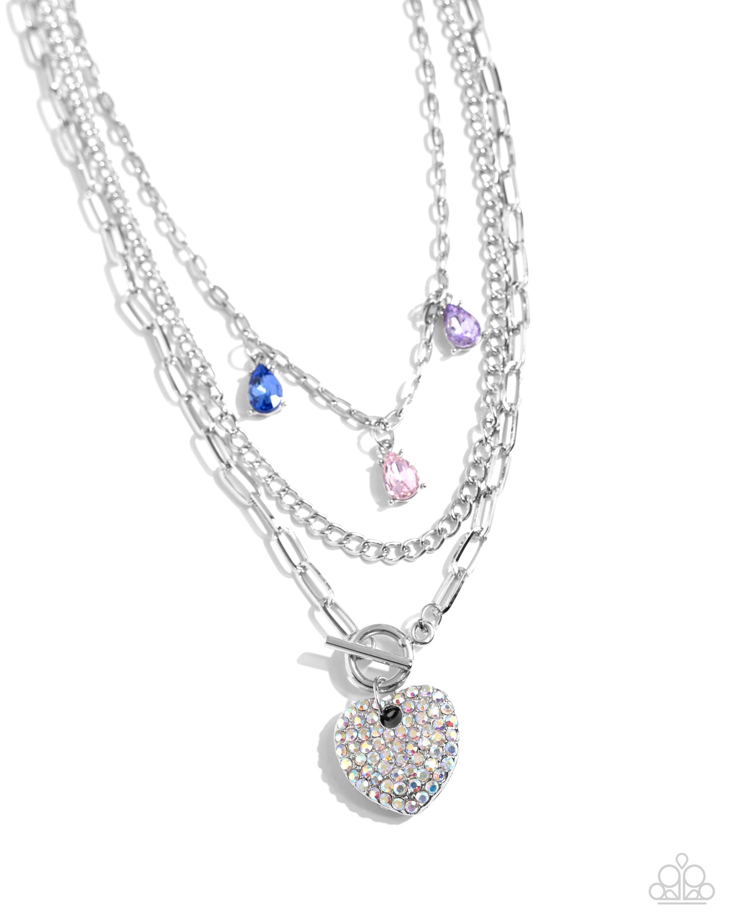<p>Three mismatched silver chains layer and loop around the neckline. A purple, light pink, and blue teardrop gem in silver-pronged fittings dangle from the uppermost chain while an iridescent-rhinestone encrusted heart pendant loops through the lowermost chain for a radiantly, romantic statement. Features an adjustable clasp closure. Due to its prismatic palette, color may vary.</p> <p><i> Sold as one individual necklace. Includes one pair of matching earrings.</i></p>
