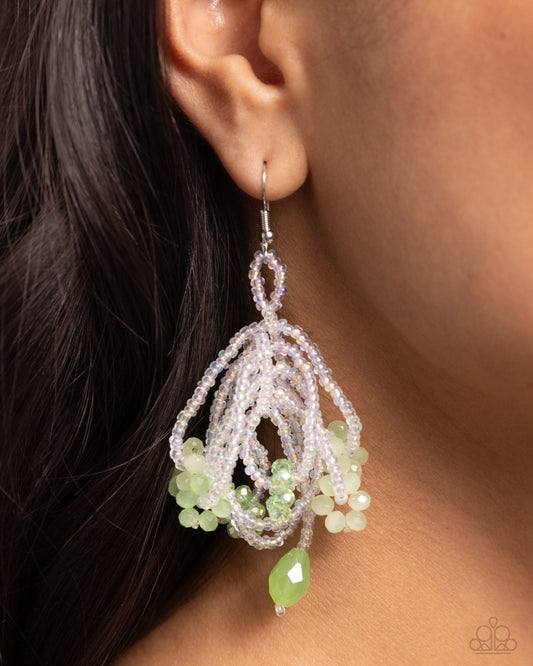 <p>A collection of clear white seed beads gives way into bundles of clear seed beads that loop below the ear. Various green faceted beads are infused and interspersed along the clear seed beads for additional refining color. A solitaire elongated green bead trails off from the copious bundles for a final whimsical touch. Earring attaches to a standard fishhook fitting.</p> <p><i> Sold as one pair of earrings.</i></p>