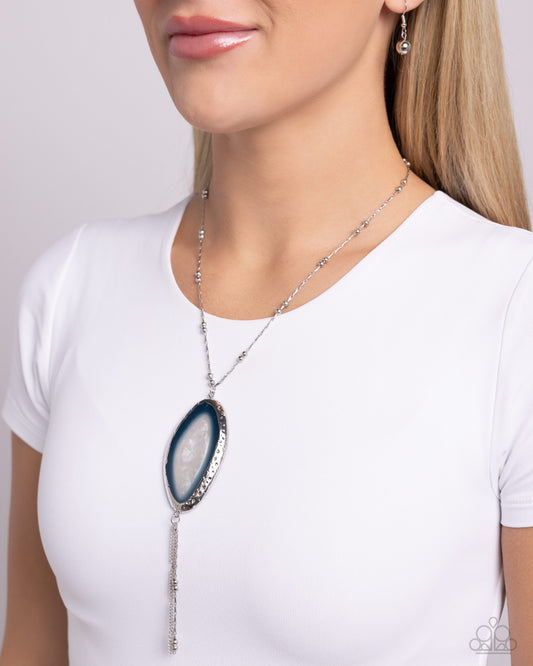 <p>Pressed in an abstract, hammered oval frame, a transparent blue geode-like stone glistens below the collar from an abstract silver satellite chain for a blissfully balanced look. Strands of dainty silver classic and satellite chains cascade from the geode pendant for additional detail and eye-catching movement. Features an adjustable clasp closure.</p> <p><i> Sold as one individual necklace. Includes one pair of matching earrings.</i></p>