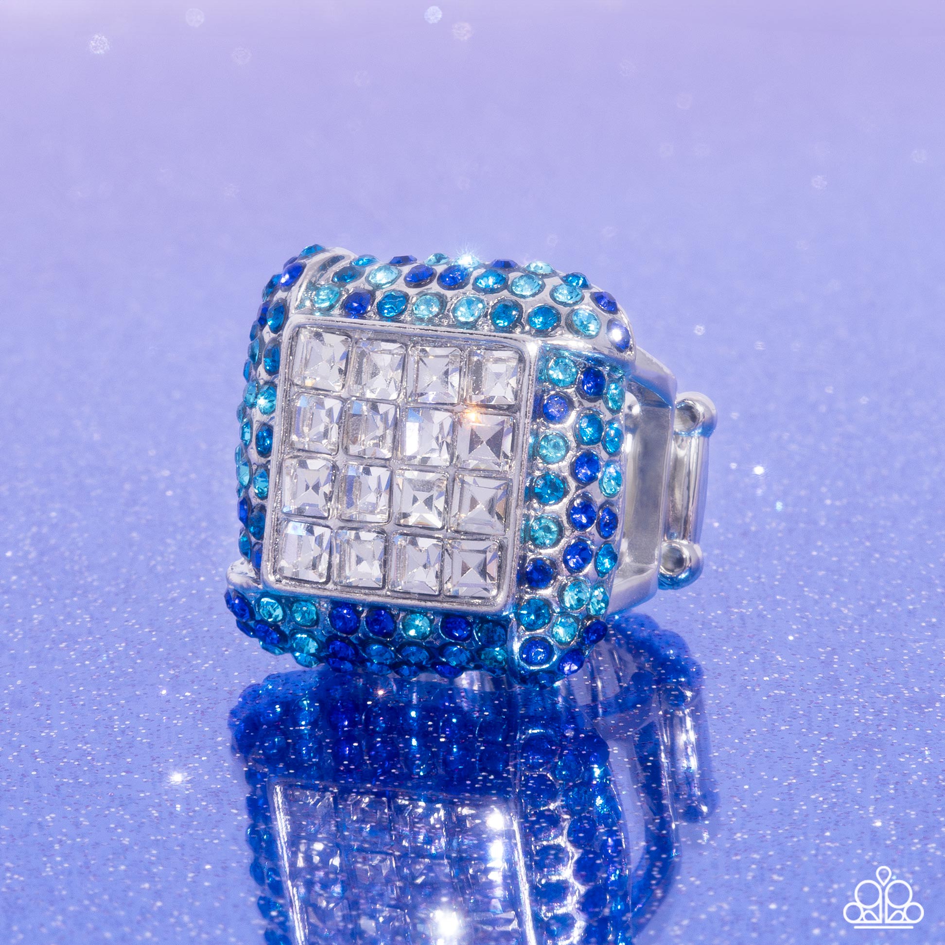 <p>Featuring a collection of faceted white square-cut gems, a thick silver frame embellished with blue multicolored rhinestones glistens atop the finger for a standout, sparkly centerpiece. Features a stretchy band for a flexible fit.</p> <p><i> Sold as one individual ring.</i></p>