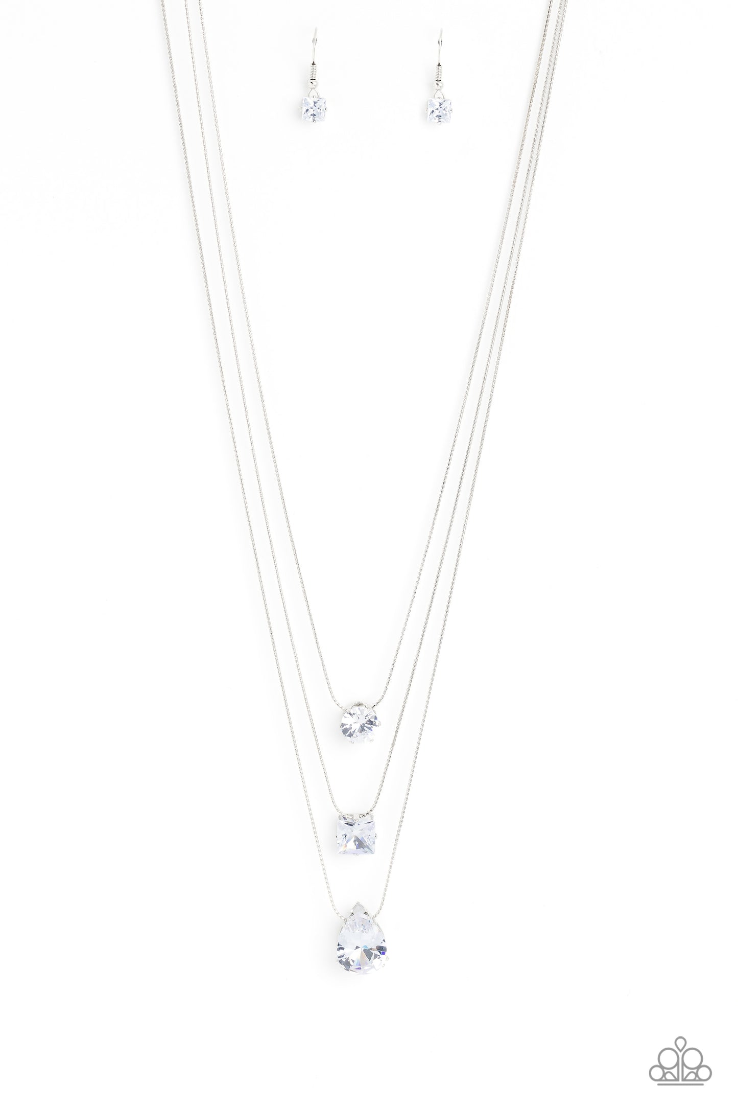 Featuring a subtle iridescent finish, exaggerated, faceted round, square, and teardrop gems layer down the chest from three sleek silver dainty chains, in a refined fashion. Features an adjustable clasp closure. Due to its prismatic palette, color may vary.  Sold as one individual necklace. Includes one pair of matching earrings.