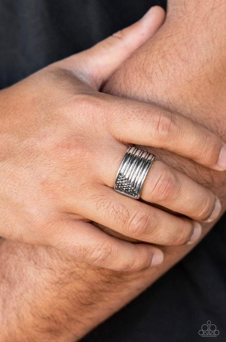 Engraved in linear patterns, the corner of a thick silver band has been chiseled away and encrusted in dainty rows of hematite rhinestones for a standout finish. Features a stretchy band for a flexible fit.  Sold as one individual ring.
