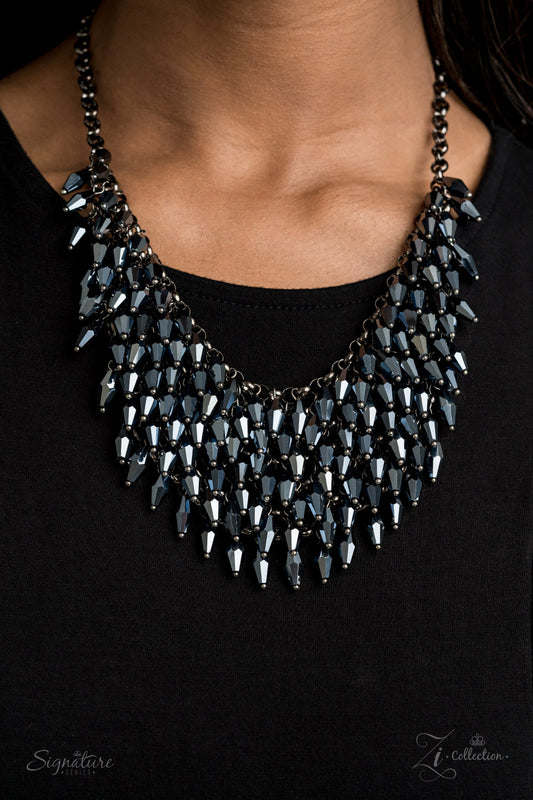 Row after row of metallic blue beads swing from an edgy net of glistening gunmetal links, layering into an edgy fringe below the collar. Featuring flashy faceted edges, the mesmerizing beads spark and sizzle into a conflagration of sparkle below the collar. Features an adjustable clasp closure.  Named after 2020 Rock the Runway winner, Heather M.  Sold as one individual necklace. Includes one pair of matching earrings.