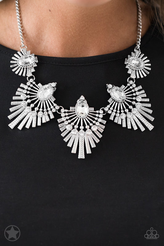 Textured metal bars flare out from a mesmerizing gem, creating a fringe of fanning frames. Sprinkled with matching white rhinestones, the dazzling display falls just below the collar for a sassy finish. Features an adjustable clasp closure.  Sold as one individual necklace. Includes one pair of matching earrings.