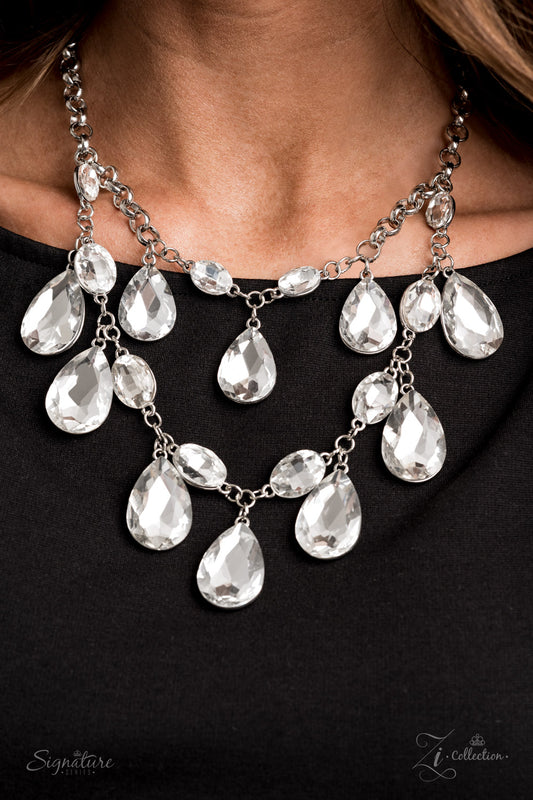 Tiers of oversized white teardrop gems demand attention as they drip from two blinding rows of elegantly linked white oval rhinestones. Infused with sections of chunky silver chain links, the sparkling rows brilliantly layer below the collar, becoming the center of every conversation. Features an adjustable clasp closure.  Named after 2020 Rock the Runway winner, Sarah H.  Sold as one individual necklace. Includes one pair of matching earrings.