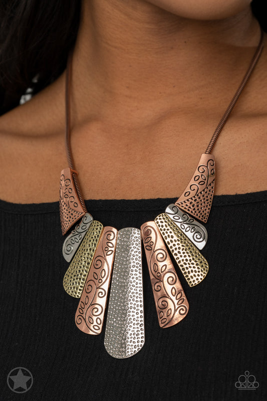 Copper, silver and brass plates featuring various hammered and filigreed textures fan out across the chest along a thick copper snake chain. The gorgeous tribal design falls gracefully below the collar into a dramatic statement piece. Features an adjustable clasp closure.  Sold as one individual necklace. Includes one pair of matching earrings.