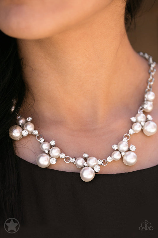 Clusters of pearls and dazzling white rhinestones join below the collar, creating refined frames. Infused with a glistening silver chain, the sections of luminescent frames trickle along the neck in a timeless fashion. Features an adjustable clasp closure.