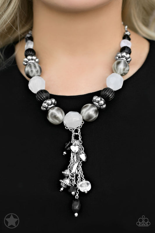Smooth beads with a marbleized black and white swirl alternate with milky white and silver accents. A tassel of chains in various lengths is decorated with black, silver, and frosty pieces. Features an adjustable clasp closure.  Sold as one individual necklace. Includes one pair of matching earrings.   Get The Complete Look! Bracelet: "Lights! Camera! Action!" (Sold Separately)