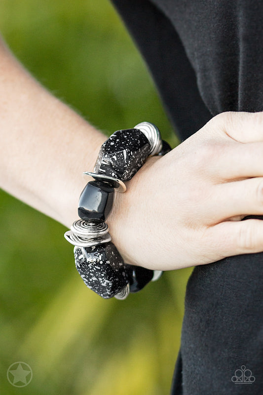 Chunky black beads with speckles of silver and a gorgeous glazed finish are threaded along a stretchy band with thick silver rings.Sold as one individual bracelet.   Get The Complete Look! Necklace: "In Good Glazes - Black" (Sold Separately)