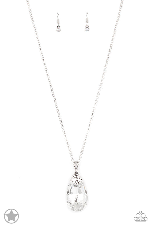 Infused with an elegantly elongated silver chain, a dramatic teardrop gem swings from the bottom of a white rhinestone encrusted silver fitting, creating a hypnotic pendant. Features an adjustable clasp closure.  Sold as one individual necklace. Includes one pair of matching earrings.