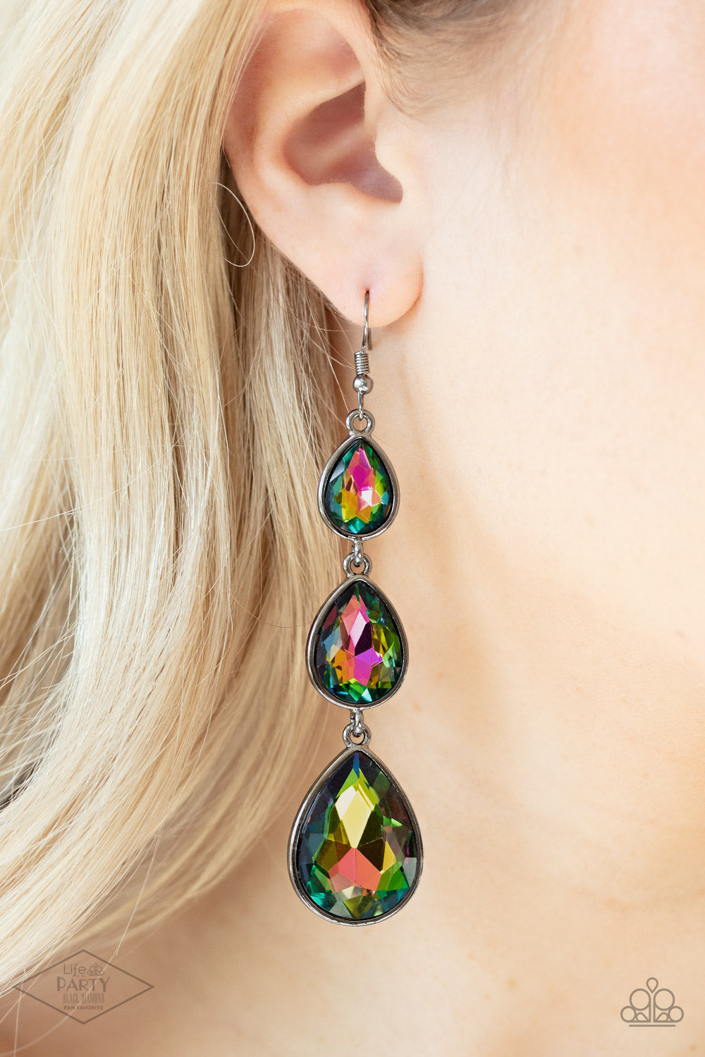Featuring sleek gunmetal frames, exaggerated oil spill teardrop rhinestones gradually increase in size as they drip from the ear. Earring attaches to a standard fishhook fitting.  Sold as one pair of earrings.   FANFAVORITE
