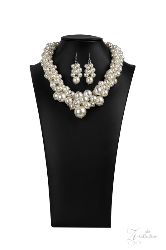 An exaggerated display of clustered pearls elegantly sweeps below the collar. The classic white pearls gradually increase in bubbly intensity as they reach the center of the regal piece, adding over-the-top timelessness to the unapologetic pearl palette. Features an adjustable clasp closure.  Sold as one individual necklace. Includes one pair of matching earrings.