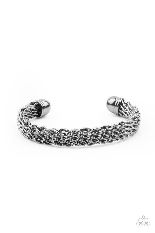 Twisting gunmetal wires interlock across the wrist, creating a thickly woven cuff.  Sold as one individual bracelet.