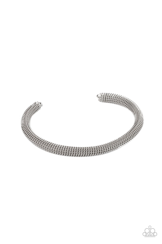 A dainty row of glistening silver chain twists around a silver cuff, creating an edgy industrial display around the wrist.  Sold as one individual bracelet.