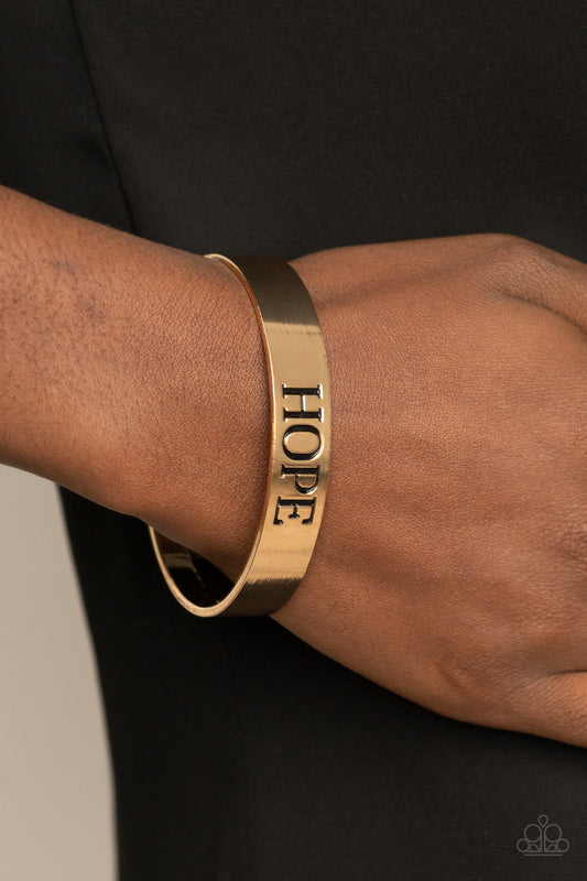 The center of a shiny gold cuff is stamped in the word, "Hope," for an inspirational look.  Sold as one individual bracelet.