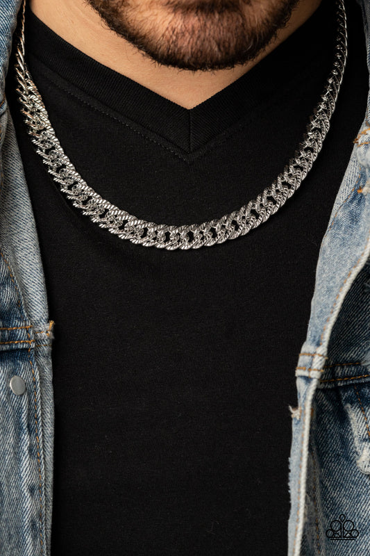 Etched in linear textures, an oversized silver chain drapes below the collar for a dramatic industrial effect. Features an adjustable clasp closure.  Sold as one individual necklace.   Get The Complete Look! Bracelet: "On The Up and UPPERCUT - Silver" (Sold Separately)