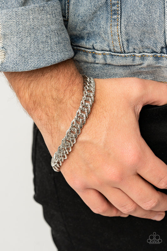 Etched in linear textures, an oversized silver chain drapes around the wrist for a dramatic industrial effect. Features an adjustable clasp closure.  Sold as one individual bracelet.   Get The Complete Look! Necklace: "Urban Uppercut - Silver" (Sold Separately)