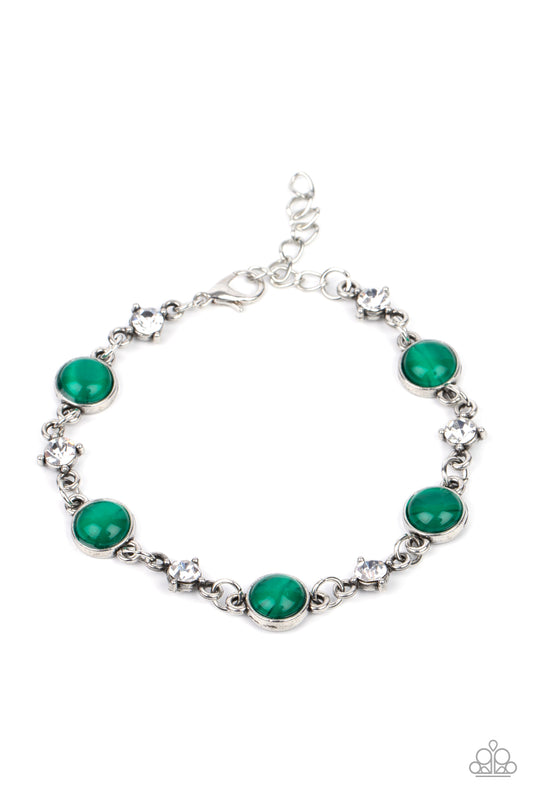 Encased in antiqued silver fittings, dainty white rhinestones and glowing Mint cat's eye stones delicately link around the wrist for a timeless finish. Features an adjustable clasp closure.  Sold as one individual bracelet.   Get The Complete Look!  Necklace: "Inner Illumination - Green" (Sold Separately)