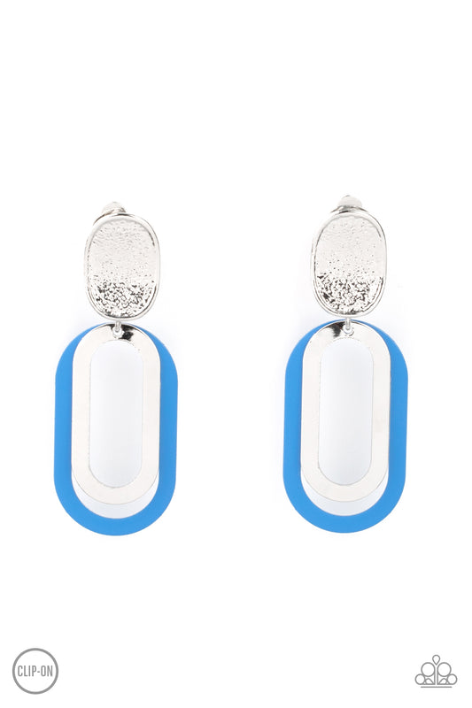 Shiny silver and French Blue oblong hoops dangle from a shimmery textured silver oval disc for an upscale finale. Earring attaches to a standard clip-on fitting.  Sold as one pair of clip-on earrings.