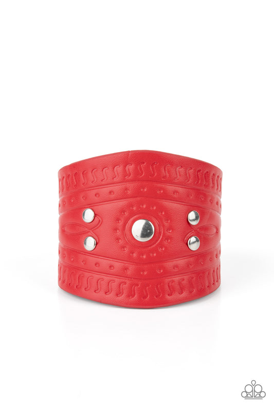 Dotted in shiny silver studs, a triangular piece of red leather is stamped in indigenous inspired patterns for an urban flair. Features an adjustable snap closure.  Sold as one individual bracelet.