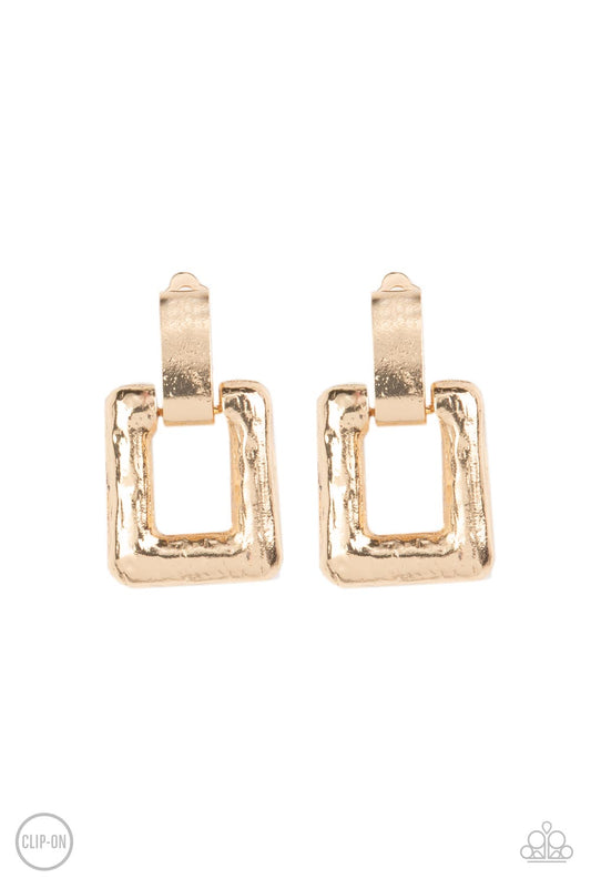 A hammered gold rectangular frame attaches to a thick gold fitting, creating a refined lure. Earring attaches to a standard clip-on fitting.  Sold as one pair of clip-on earrings.   Clip On Earring