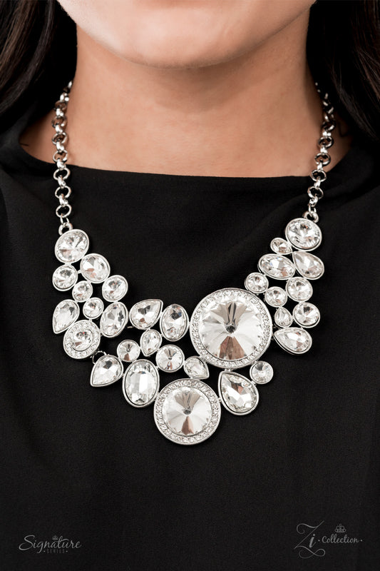 Featuring an oversized collection of round, oval, and teardrop white rhinestones, an exaggerated explosion of dynamite dazzle coalesces into three separate frames below the collar. The combustible frames flawlessly link into a mismatched arrangement of legendary sparkle. Features an adjustable clasp closure.