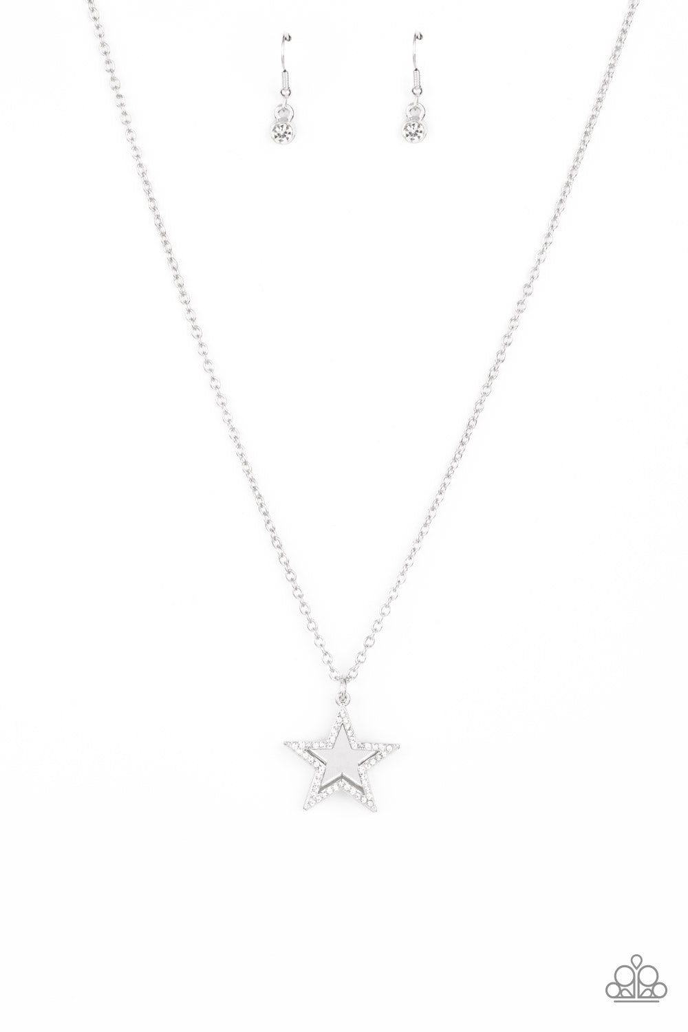 A white rhinestone encrusted silver star delicately overlaps with a shiny silver star below the collar, creating a sparkly patriotic pendant. Features an adjustable clasp closure.  Sold as one individual necklace. Includes one pair of matching earrings.