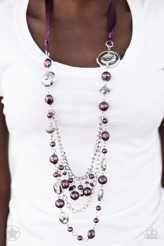 A silky purple ribbon replaces a traditional chain to create a timeless look. Pearly deep purple beads and funky silver pieces intermix with varying lengths of silver chains to give a fresh take on a Victorian-inspired piece.   Sold as one individual necklace. Includes one pair of matching earrings.