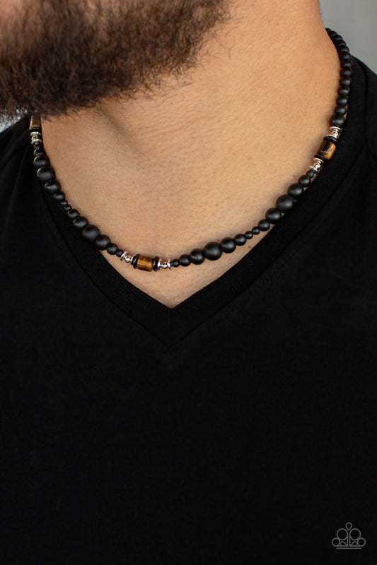 Grounding sections of dainty silver beads and Tiger's eye stone accents adorn a strand of black stone beads, creating an earthy compliment below the collar. Features an adjustable clasp closure.  Sold as one individual necklace.