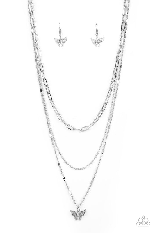 Dotted with a dainty white rhinestone, a decoratively layered silver butterfly swings from the bottom of a display of mismatched silver chains for a whimsically fluttering fashion. Features an adjustable clasp closure.  Sold as one individual necklace. Includes one pair of matching earrings.