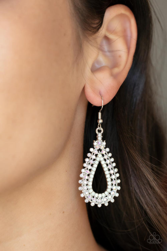 Glittery rows of white, iridescent, and opal rhinestones stack into a solitaire sparkly teardrop frame for a glamorous fashion. Earring attaches to a standard fishhook fitting.  Sold as one pair of earrings.