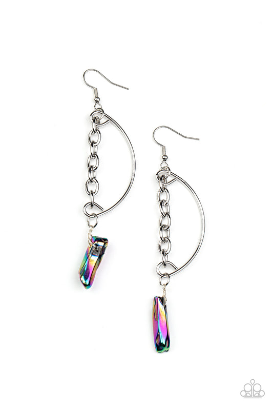 Featuring an oil spill finish, a raw rock-like bead swings from the bottom of a solitaire silver chain that attaches to a bowing silver bar for an edgy look. Earring attaches to a standard fishhook fitting. As the stone elements in this piece are natural, some color variation is normal.  Sold as one pair of earrings.
