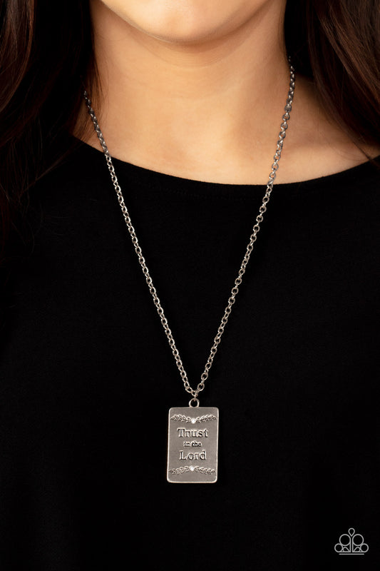 Bordered in leafy patterns and dainty white rhinestones, the center of a silver rectangular frame is stamped in the phrase, "Trust in the Lord," for an inspiring finish. Features an adjustable clasp closure.  Sold as one individual necklace. Includes one pair of matching earrings.