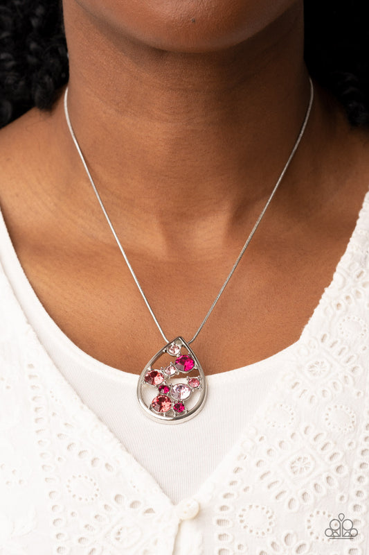 A bubbly collection of pink, Pale Rosette, and Fuchsia Fedora rhinestones coalesce inside an airy silver teardrop, resulting in an effervescently elegant pendant at the bottom of a rounded silver snake chain. Features an adjustable clasp closure.  Sold as one individual necklace. Includes one pair of matching earrings.