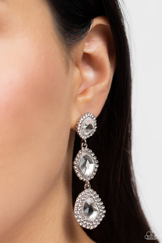 Bordered in dainty white rhinestones, a trio of imperfect white gems delicately link into a dazzling lure. Earring attaches to a standard post fitting.  Sold as one pair of post earrings.