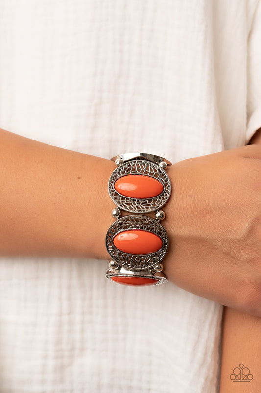 Bordered in airy stenciled frames, burnt orange beaded silver frames join pairs of silver beads along stretchy bands along the wrist for a seasonal pop of color.  Sold as one individual bracelet.