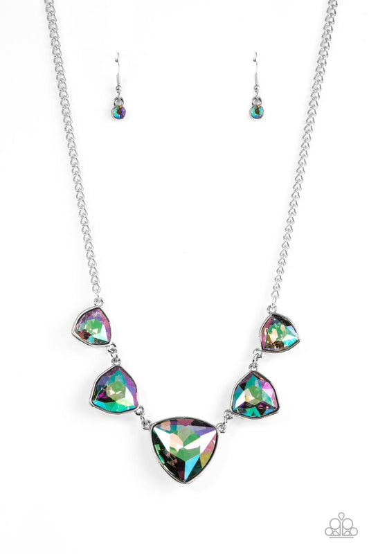 Encased in sleek silver fittings, an oversized collection of UV geometric gems gradually increase in size as they link below the collar for a stellar statement. Features an adjustable clasp closure. Due to its prismatic palette, color may vary.  Sold as one individual necklace. Includes one pair of matching earrings.