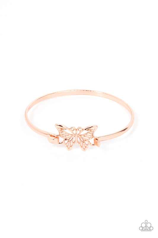 Attached to a shiny copper bangle-like bracelet, a shiny copper butterfly flutters atop the wrist for a dainty fashion. Features a hook and eye closure.  Sold as one individual bracelet.