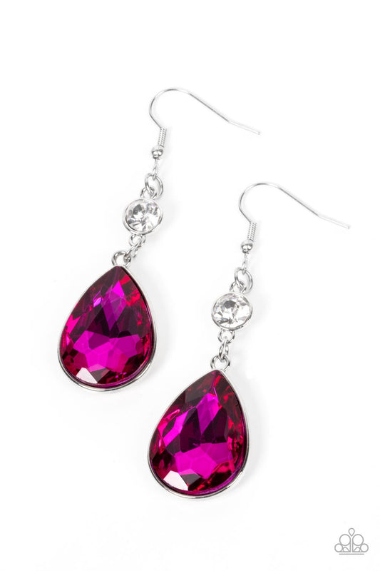 A dramatically oversized Fuchsia Fedora teardrop gem sparkles from the bottom of a stunning solitaire white rhinestone, resulting in a jaw-dropping dazzle. Earring attaches to a standard fishhook fitting.  Sold as one pair of earrings.