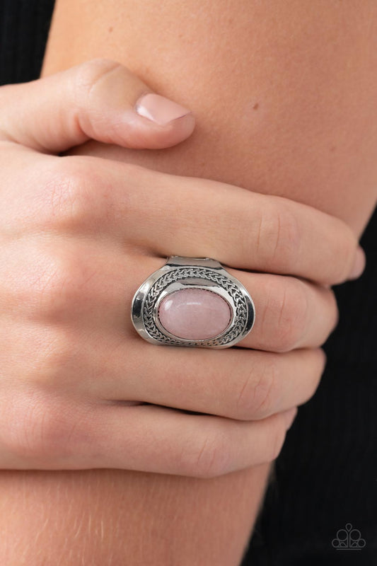 Bordered in a frame of chain-like details, an oval rose quartz stone is pressed into the center of an oval silver frame as it folds around the finger for an enchantingly earthy look. Features a stretchy band for a flexible fit.  Sold as one individual ring.