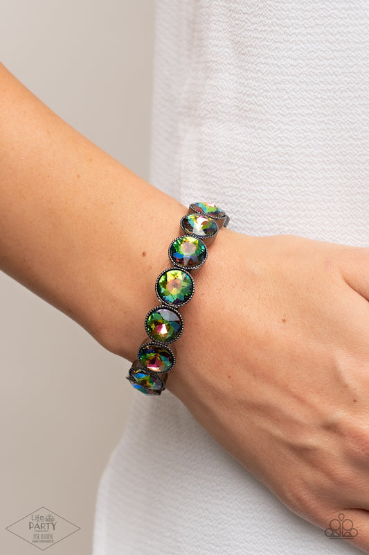 Faceted oil spill gems are pressed into sleek gunmetal frames. The glittery frames are threaded along stretchy bands, creating a glamorous look around the wrist.  Sold as one individual bracelet.